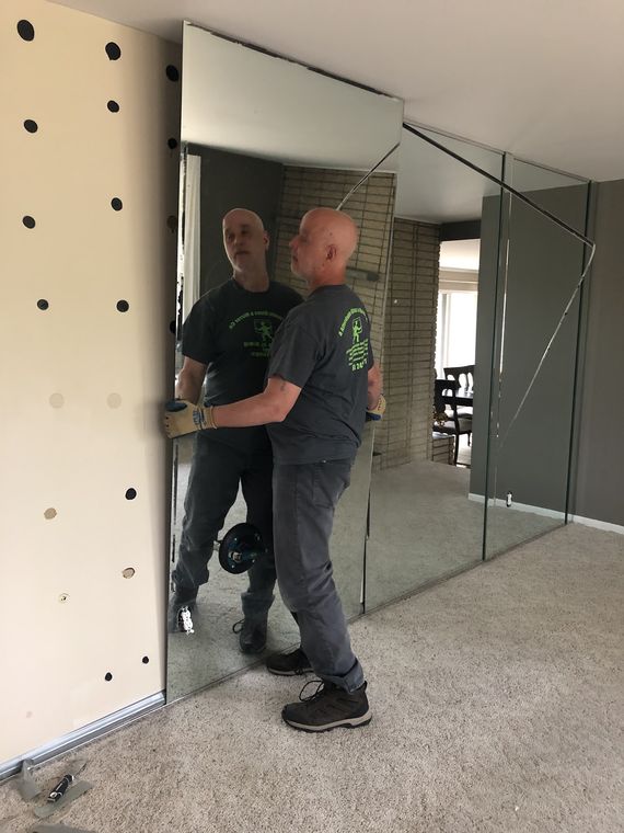 Charles and Greg setting a mirror panel