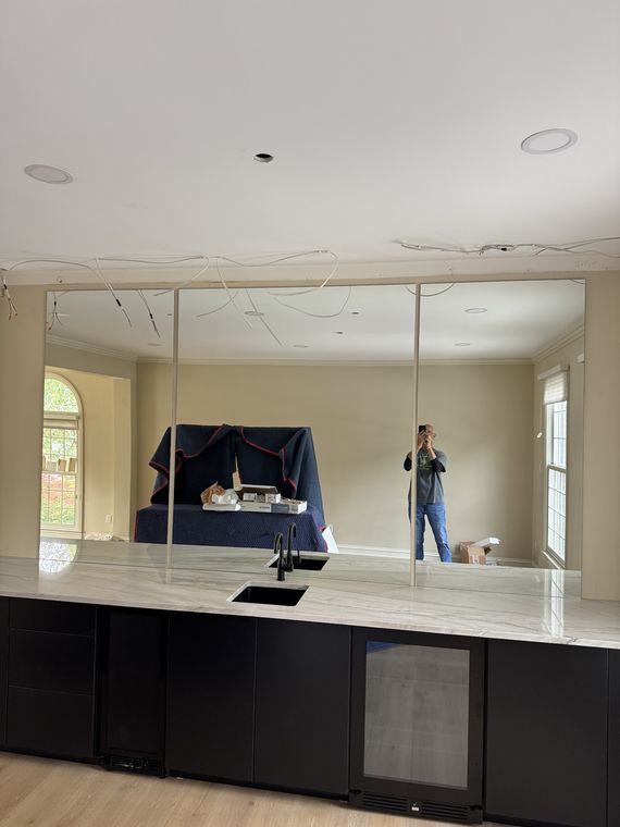 Large mirrored wall behind a home bar