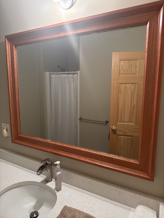 Framed mirror over a bathroom vanity