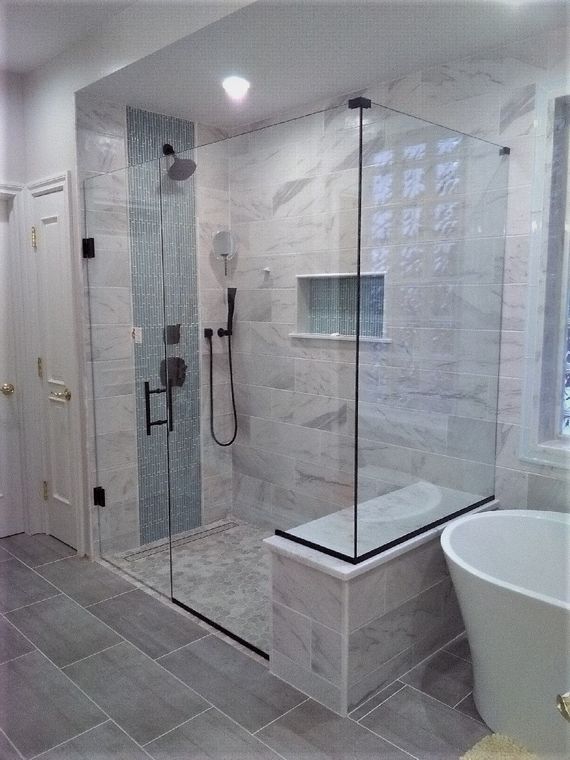 Frameless shower glass in a marble bathroom