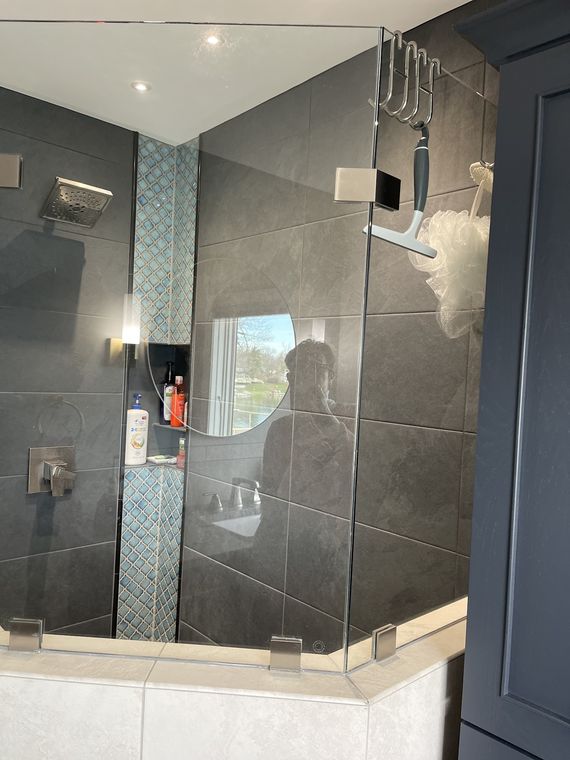 Slate-tiled shower with glass enclosure