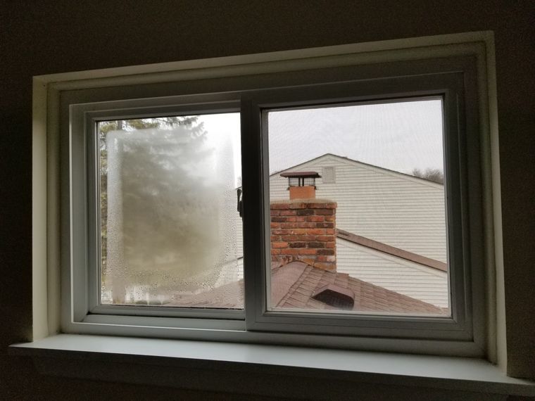 One fogged pane beside one clear pane showing a failed seal